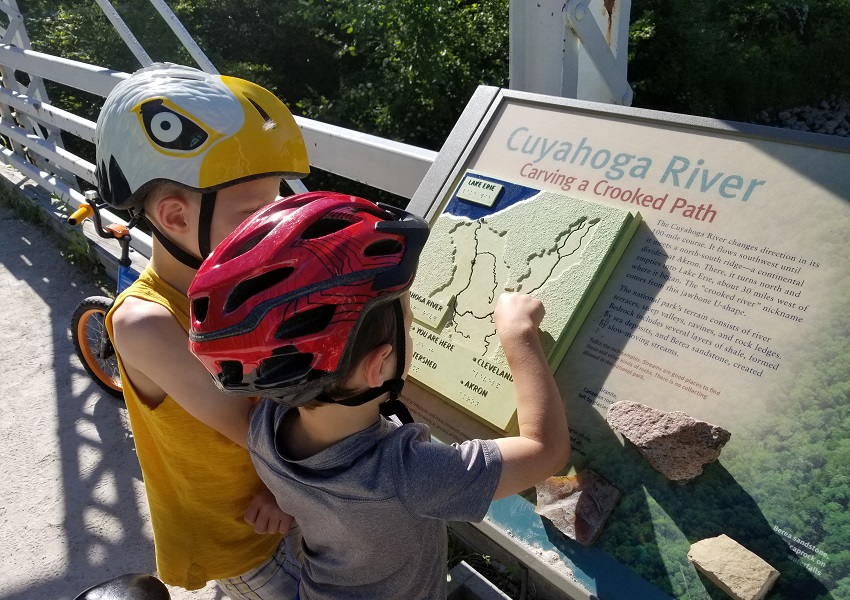 Quinton and Miles are learning about the unique history of the Ohio & Erie Canalway and local river valleys through the robust interpretive displays along the Towpath Trail. Photo courtesy of Heather Englander.